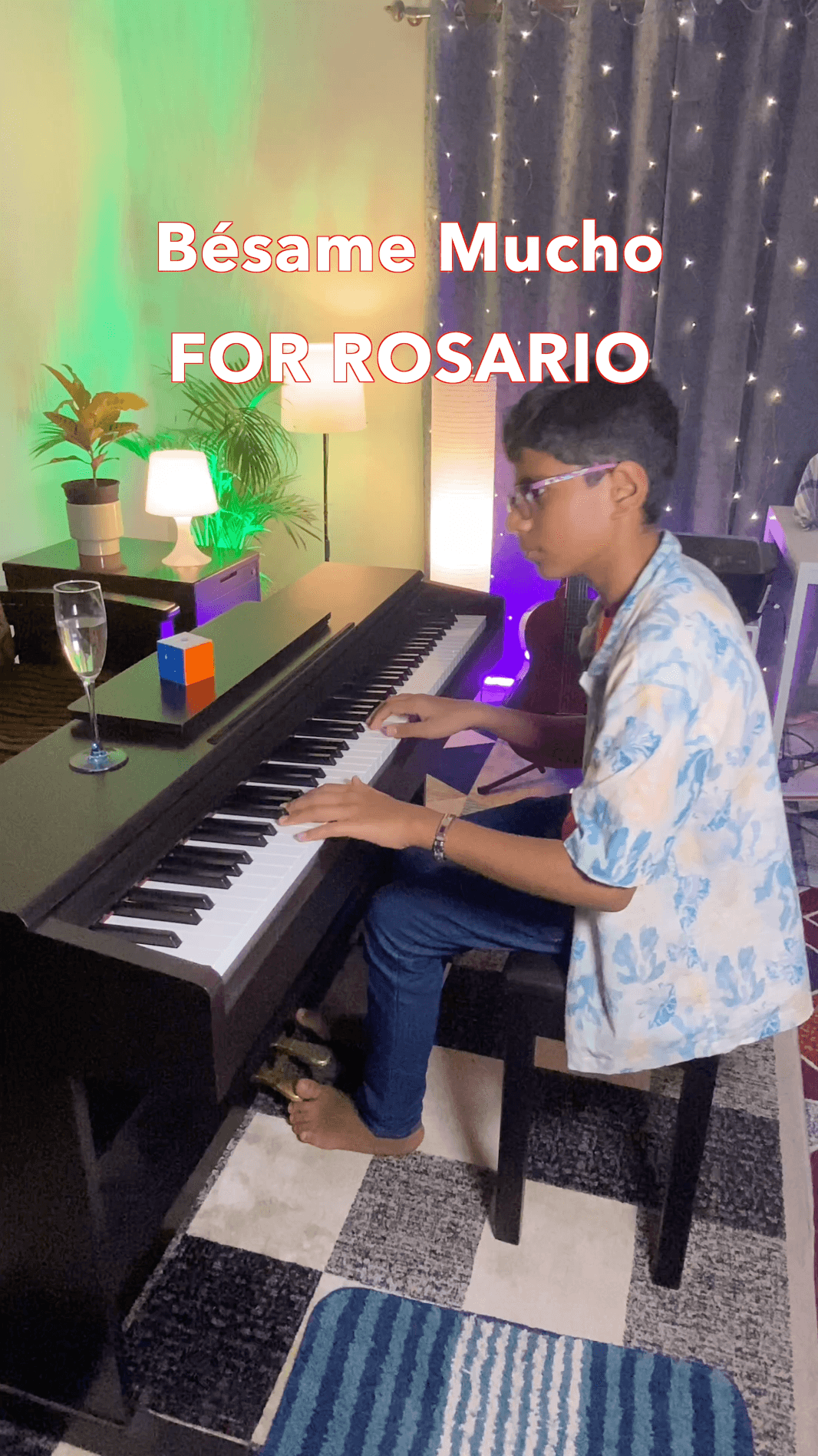 Bala playing a digital piano at home, with the words Bésame Mucho across the photograph.